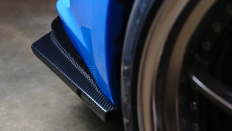 Close-up of a wheel with a blue protective cover on a concrete surface